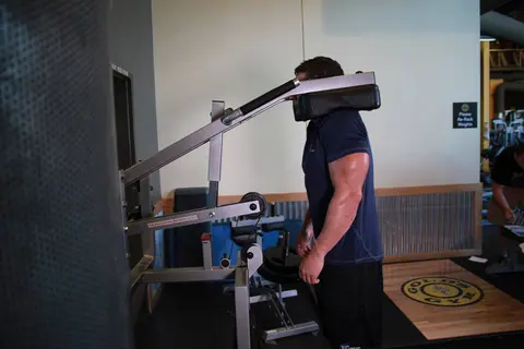 Calf-Machine Shoulder Shrug — end position
