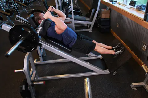 Narrow Stance Hack Squats — end position