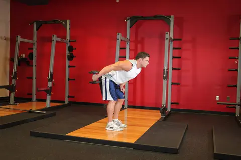 Standing Bent-Over One-Arm Dumbbell Triceps Extension — end position
