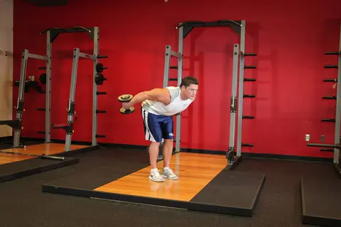 Standing Bent-Over Two-Arm Dumbbell Triceps Extension — end position