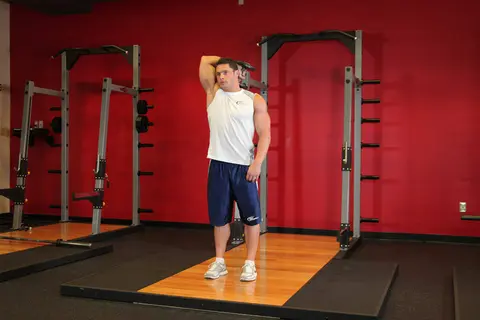 Standing One-Arm Dumbbell Triceps Extension — end position